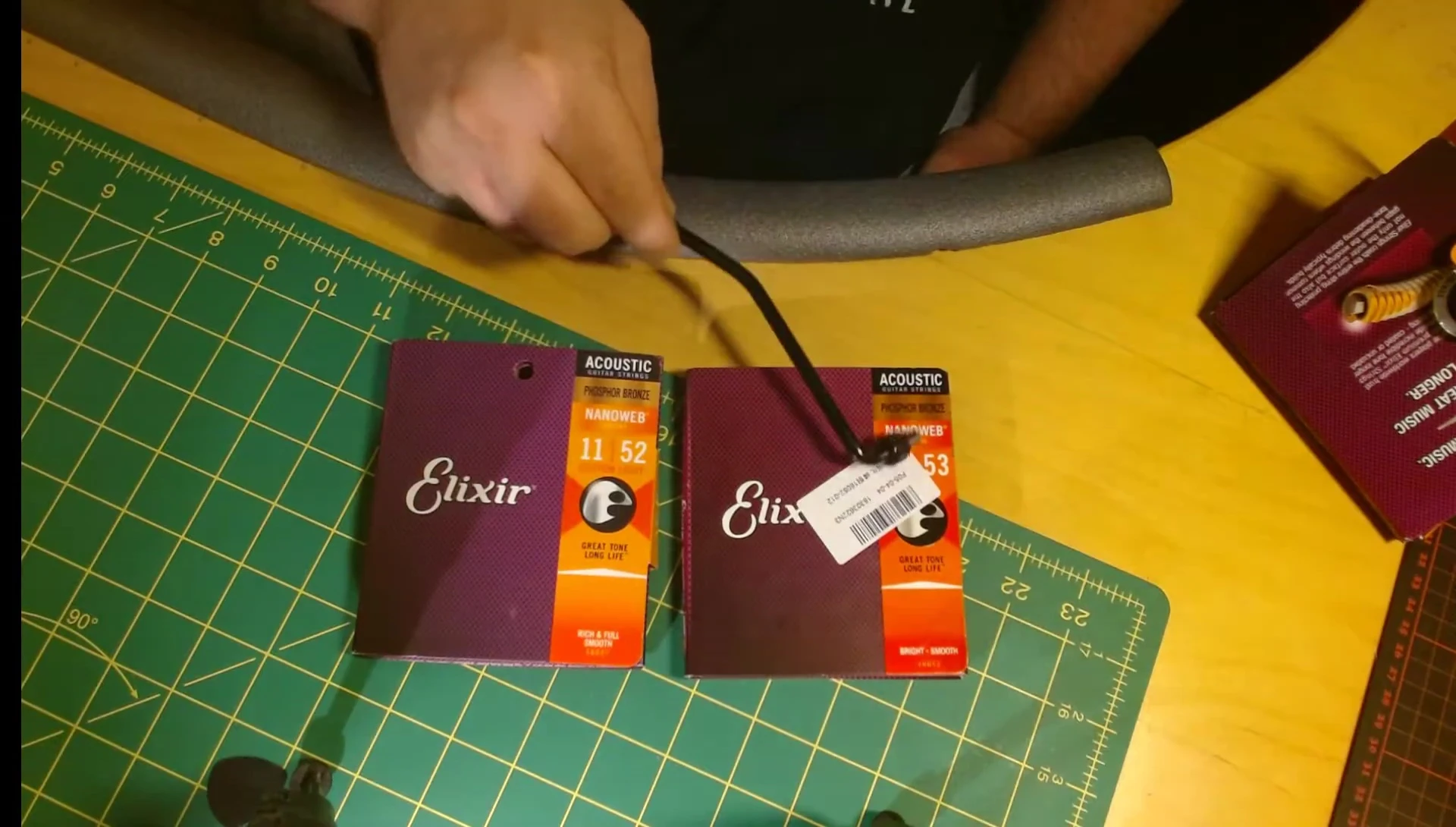 Comparison of fake and real Elixir string packaging, highlighting the color difference.