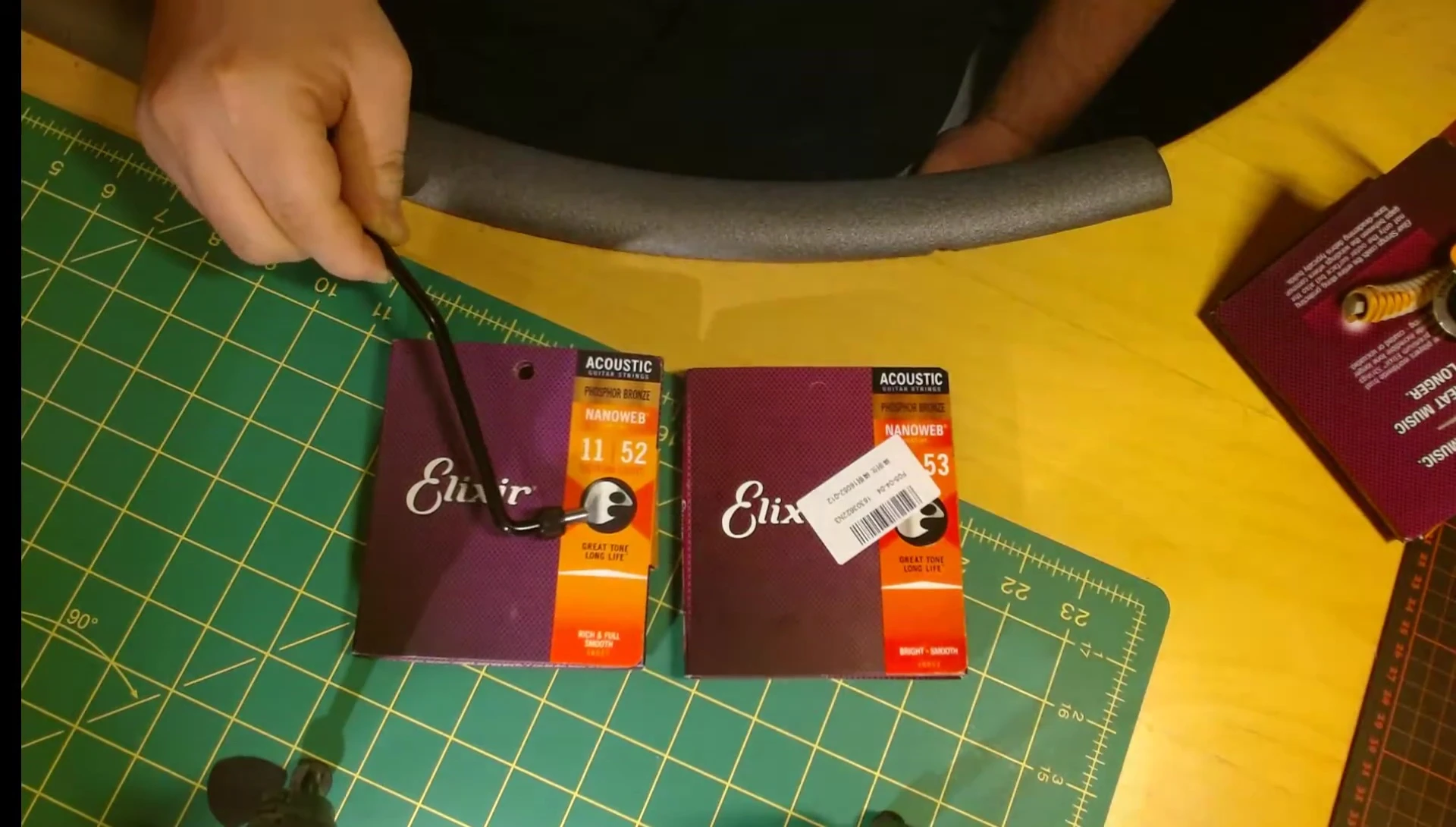 Close-up of authentic Elixir string packaging, showcasing its brighter color.