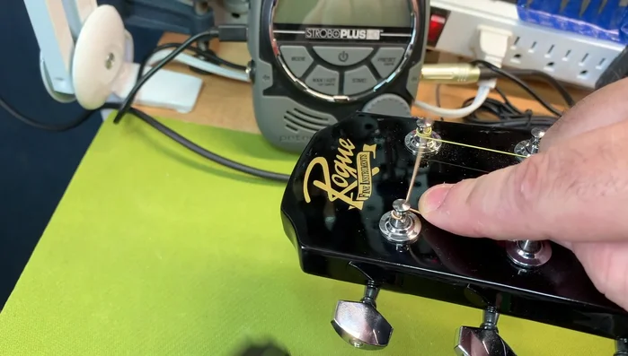 Pull it tight, hold it, and wind, aiming for two to three wraps.