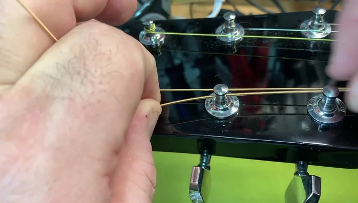 Pull the string straight through and back to give it slack.