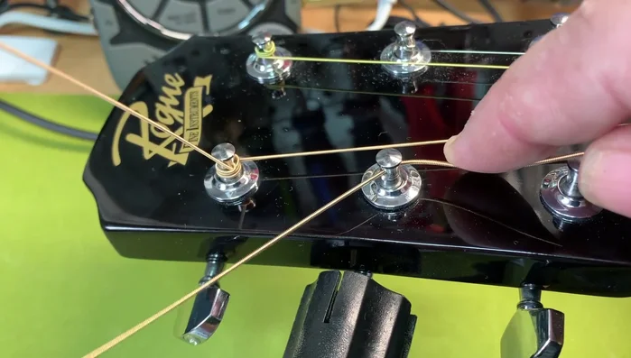 Hold the string and wind it from top to bottom, aiming for two to three turns.