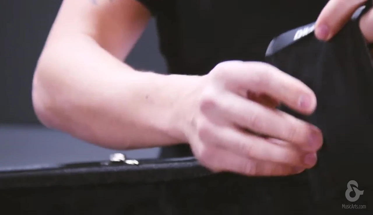 Demonstration of placing the humidity packets in the soundhole pouch.
