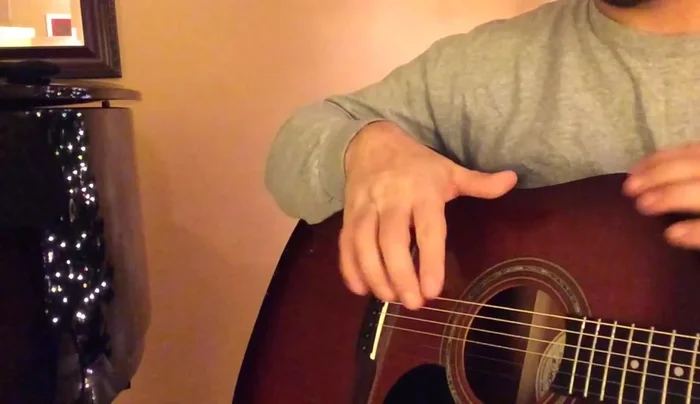 Stretch the strings by pressing down on each fret individually and pulling gently on the string to improve tuning stability.