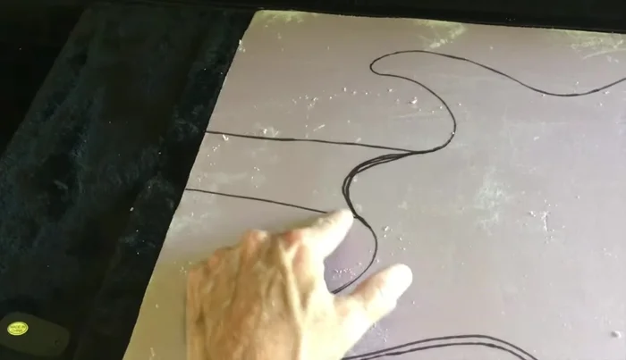 Cut out the traced shape, using a jigsaw for the main body and a belt sander (or alternative method) to shape the neck cutout.