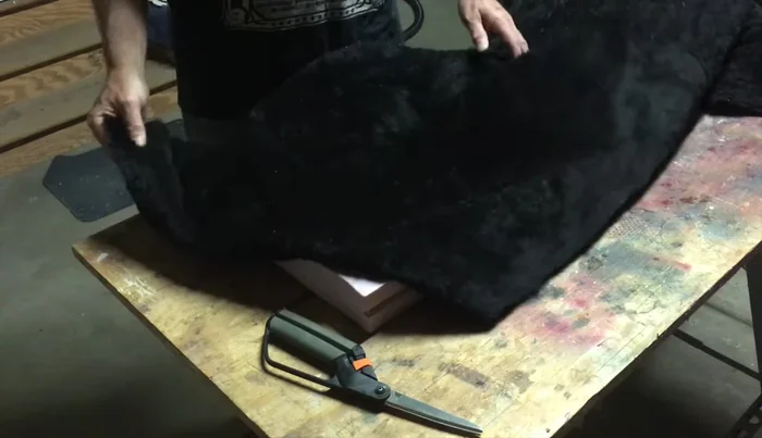 Lay out faux fur over the insert, ensuring enough overhang to tuck and blend seamlessly with the existing fur.