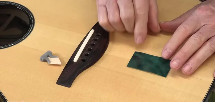 Use magnetic viewing film and a cleat holder to precisely position the cleat inside the guitar.