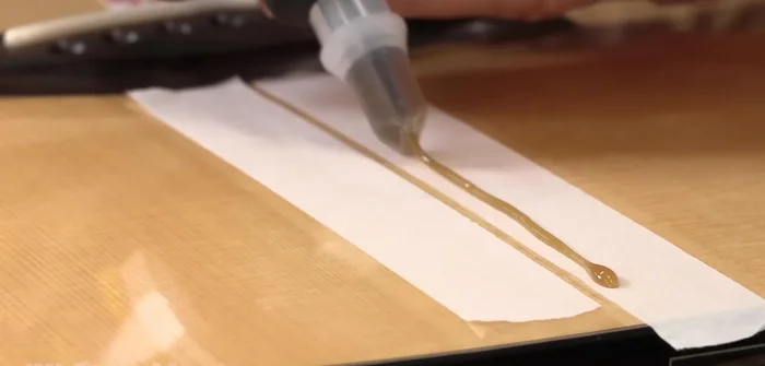 Clamp lightly using a flat callus and wax paper to keep the crack flush.