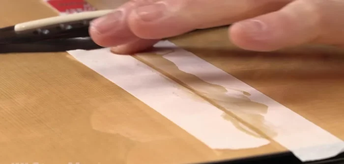 Clamp lightly using a flat callus and wax paper to keep the crack flush.