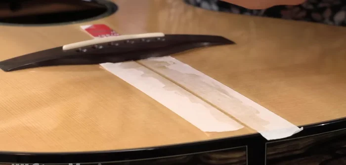 Clamp lightly using a flat callus and wax paper to keep the crack flush.