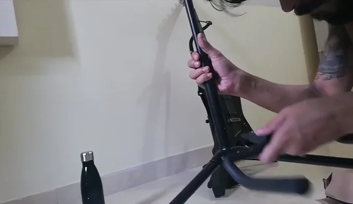 Connecting the guitar rest: Find the protruded part on the rest and insert it into the corresponding hole on the middle support.