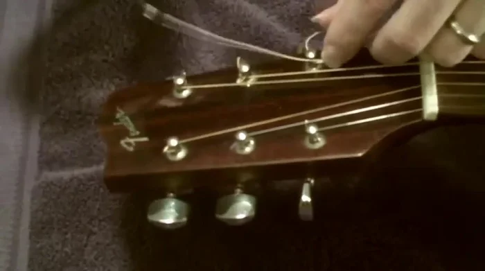 Tie a simple knot to secure the string to the tuning peg.