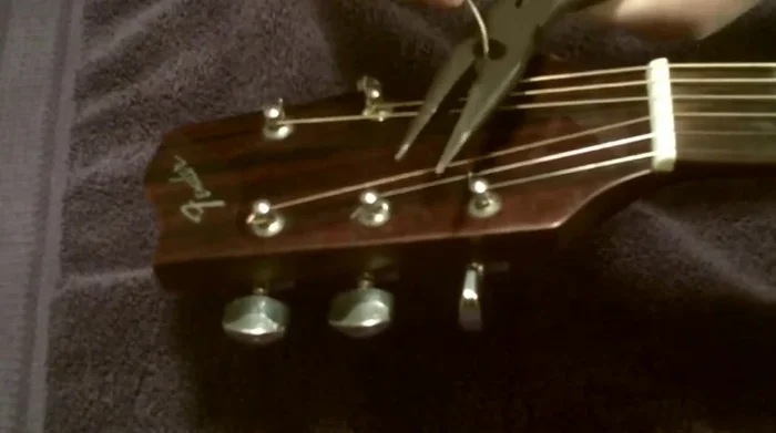 Trim excess string at the tuning peg.