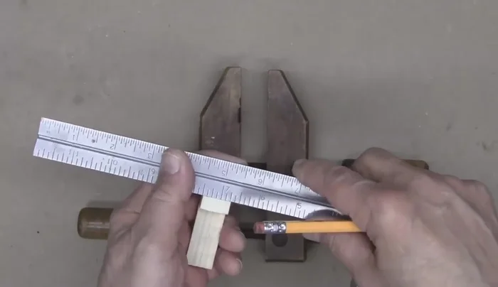 Create a channel in the wood piece using a saw, file, or chisel, matching the width of your guitar's string post.