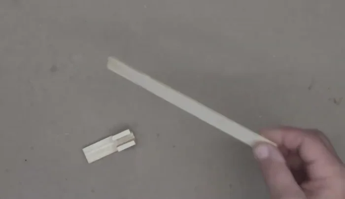 Glue and clamp the small wood pieces onto the ends of the main piece to prevent slippage.