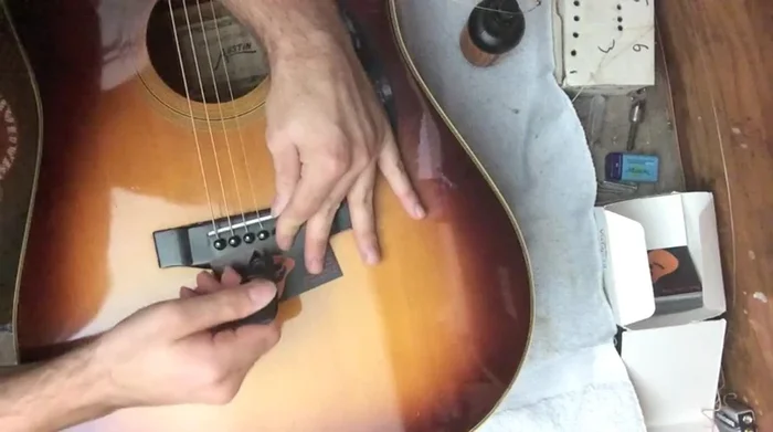 Utilize a specialized bridge pin puller (like the Stuart McDonald). Place something protective under the puller to safeguard the bridge.