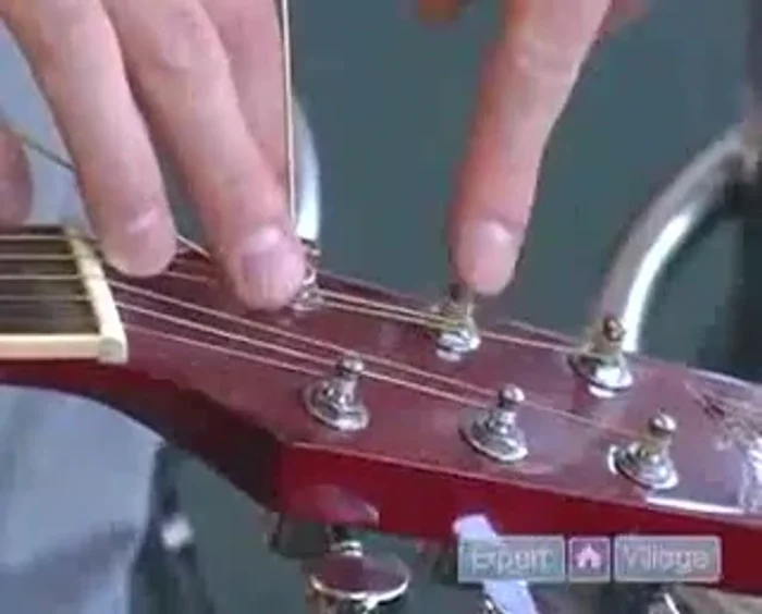 Wind the string onto the tuning peg, ensuring the wraps are neat, go underneath each other, and are all facing the same direction. Aim for 2-3 wraps.