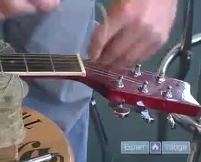 Wind the string onto the tuning peg, ensuring the wraps are neat, go underneath each other, and are all facing the same direction. Aim for 2-3 wraps.