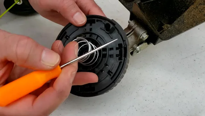 Locate the tabs with grooves on both sides of the head (where the lock symbols are).