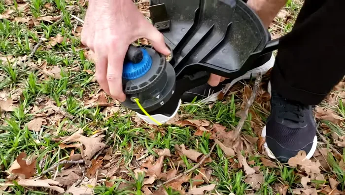 Hold the screwdriver in place with your feet and twist the top part of the head with both hands to open it.