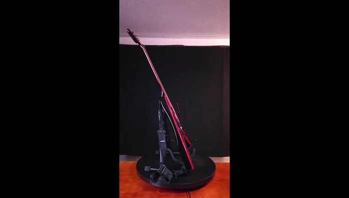 Testing the stand's compatibility with a Flying V guitar. Note: good fit with widest setting.