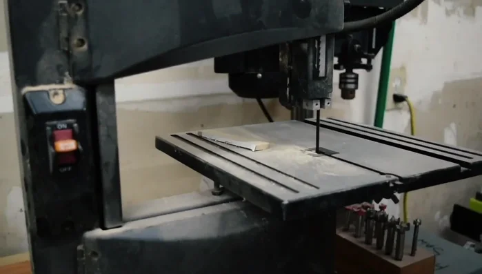 Use a bandsaw to cut along the lines, leaving slightly outside the line for sanding.