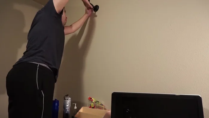 Attach the guitar holder itself to the mounted backing plate using the provided screws.