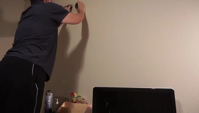 For sheetrock walls, pre-drill pilot holes (optional but recommended). You can use nails to mark the spot or screw in and out to make indentations and then hammer the nails in.