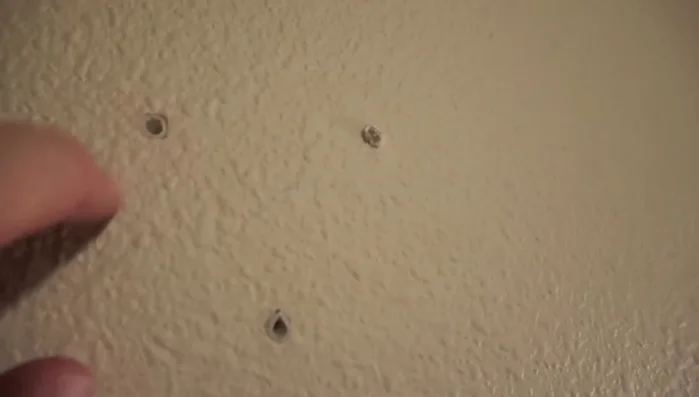 Insert the sheetrock anchors into the pre-drilled holes and hammer them in until flush with the wall. (If using studs, this step is unnecessary).